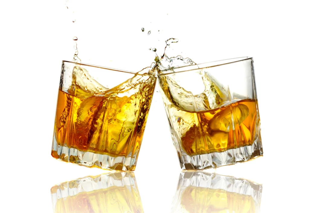two-whiskey-glasses-clinking-together-isolated_80510-459-1